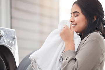 Image showing Smelling, cleaning or happy woman with laundry, machine and home for clothes, fabric and housekeeping. Scent, female person and cleaner washing items in laundromat with routine, smile and service