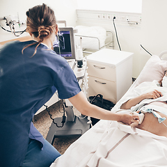 Image showing Prenatal medical exam. Female doctor using ultrasound scanner for gynecologist telling and showing patient embryo. Fertility pregnancy ovulation concept.