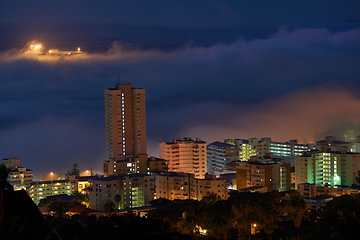 Image showing Outdoor, buildings and view of city at night with lights, skyscrapers and urban landscape for holiday or vacation in New York. Location, travel and dark with cityscape in evening downtown for journey