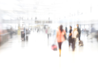 Image showing Blurred picture, people or tourists in rush with suitcase for urgency, walking or late vacation. Commuter, airport or terminal hurry for flight, train and bus in station for work trip or holiday