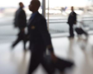 Image showing Blurred, airport and people hurry with suitcase, urgency or walking for vacation or business. Catch flight, tourist and rush for plane, train and bus in station for work trip, holiday or travel