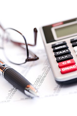 Image showing Tax calculator pen and glasses