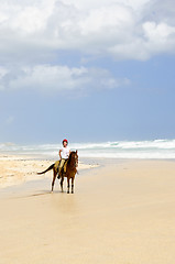 Image showing Girl riding horse on beach