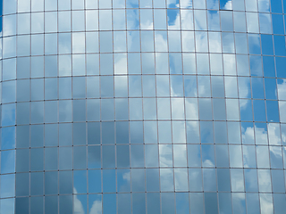 Image showing Blue sky with clouds reflected in glass windows of skyscraper