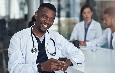 Image showing Black doctor, smile and portrait on smartphone in office for medicare, medicine or healthcare with lab coat. Person, happy and medical, medic and surgeon in hospital with resting, meeting and email