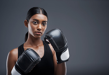 Image showing Portrait, boxing gloves and Indian woman in studio for sports, combat and training for fitness. Self defence, boxer or mma fighter for performance, workout and muay thai and cardio or impact exercise