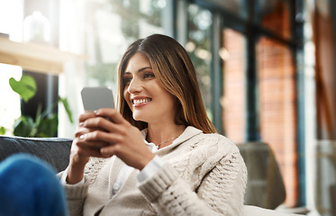 Image showing Happy woman, relax and texting with phone for social media, communication or browsing at home. Female person with smile on mobile smartphone for online chatting, app or scrolling on living room sofa