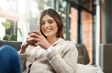 Image showing Happy woman, relax and browsing with phone for social media, communication or texting at home. Female person with smile on mobile smartphone for online chatting, app or scrolling on living room sofa