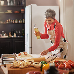 Image showing Food, cooking and senior woman in kitchen with olive oil, egg or flour for meal prep, fun or hobby with fresh ingredients at home. Nutrition, wheat or elderly lady with traditional Italian pasta dish