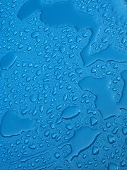 Image showing Water drops over blue plastic material