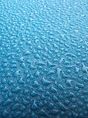 Image showing Water drops over blue plastic material