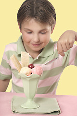 Image showing Tucking into a sundae