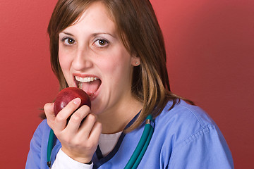Image showing Nurse Biting An Apple