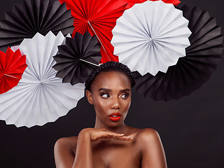 Image showing Black woman, skincare and fans in studio with makeup, origami and creative for design backdrop. Model, background and cosmetic care for treatment, thinking with vision or dermatology for wellness