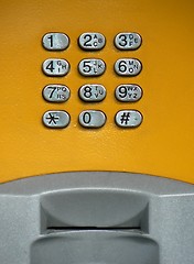 Image showing Public phone yellow keypad