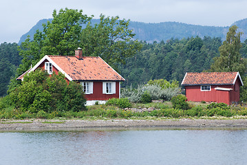 Image showing Two red houses by the sea