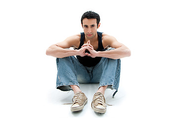 Image showing Handsome guy sitting on floor