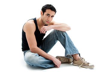 Image showing Handsome guy sitting on floor