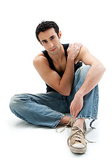 Image showing Handsome guy sitting on floor