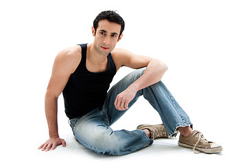 Image showing Handsome guy sitting on floor