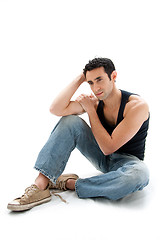 Image showing Handsome guy sitting on floor