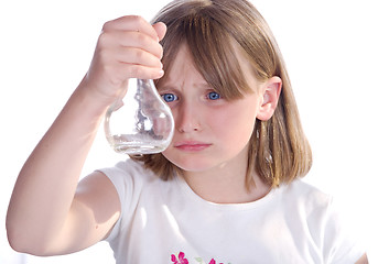 Image showing girl looking at bottle