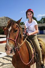 Image showing Girl riding horse