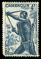 Image showing Vintage stamp from Cameroon depicting a tribal hunter