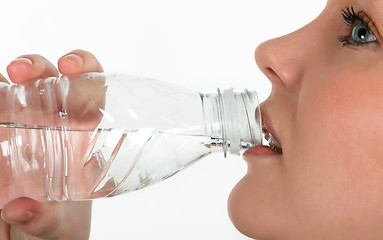 Image showing Beautiful girl drinking mineral water