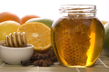 Image showing fresh honey with honeycomb, spices and fruits