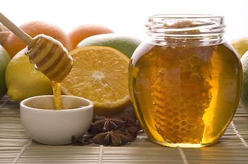 Image showing fresh honey with honeycomb, spices and fruits