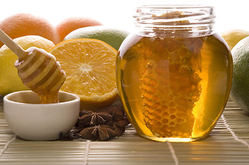 Image showing fresh honey with honeycomb, spices and fruits