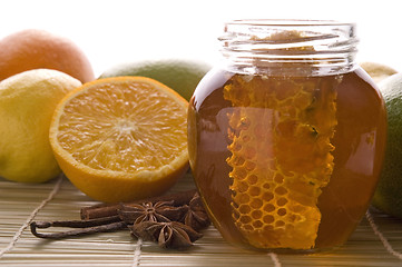 Image showing fresh honey with honeycomb, spices and fruits