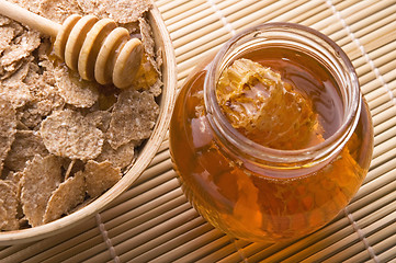 Image showing fresh honey with honeycomb and breakfast flakes