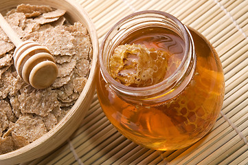 Image showing fresh honey with honeycomb and breakfast flakes