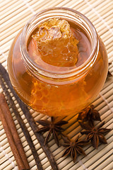 Image showing fresh honey with honeycomb and spices