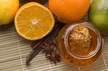 Image showing fresh honey with honeycomb, spices and fruits