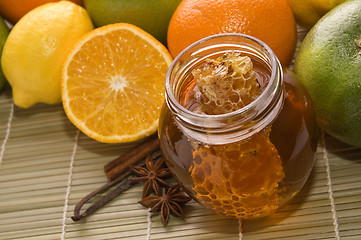 Image showing fresh honey with honeycomb, spices and fruits