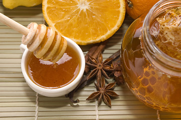 Image showing fresh honey with honeycomb, spices and fruits