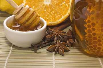 Image showing fresh honey with honeycomb, spices and fruits