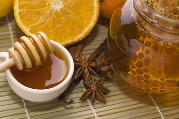 Image showing fresh honey with honeycomb, spices and fruits