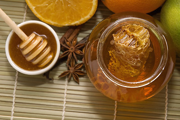 Image showing fresh honey with honeycomb, spices and fruits