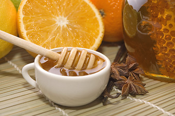 Image showing fresh honey with honeycomb, spices and fruits