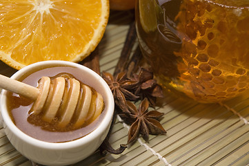 Image showing fresh honey with honeycomb, spices and fruits