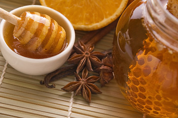 Image showing fresh honey with honeycomb, spices and fruits