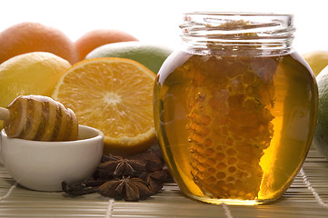 Image showing fresh honey with honeycomb, spices and fruits