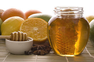 Image showing fresh honey with honeycomb, spices and fruits