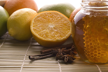 Image showing fresh honey with honeycomb, spices and fruits