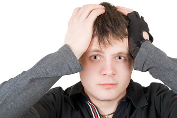 Image showing The young man pressure a head. Isolated