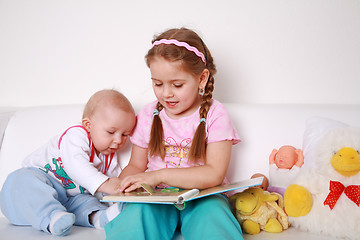 Image showing Adorable kids reading and playing